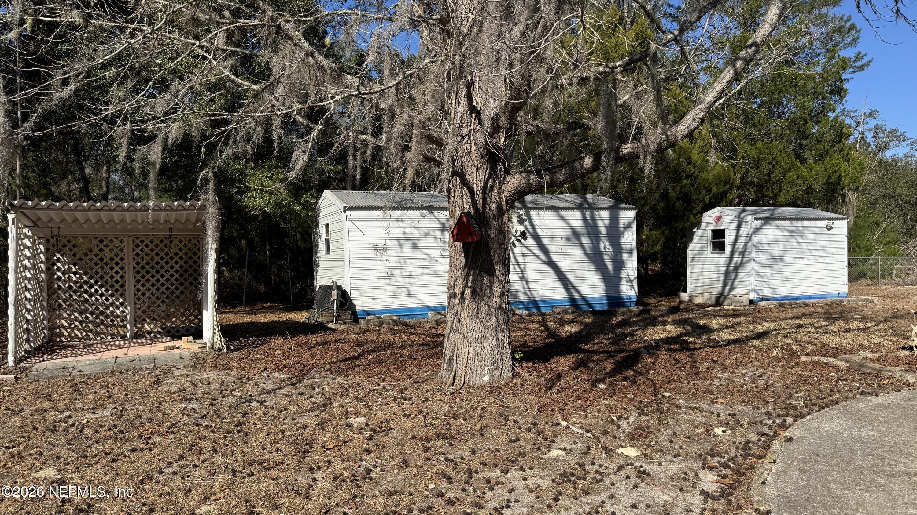 105 Rachel Road Interlachen, FL 32148 - Photo 6 of 24 a backyard of a house with barbeque oven table and chairs