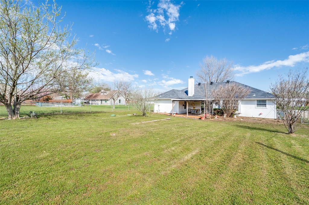 629 Concho Drive Oak Point, TX 75068 - Photo 29 of 35 a front view of a house with a garden and plants