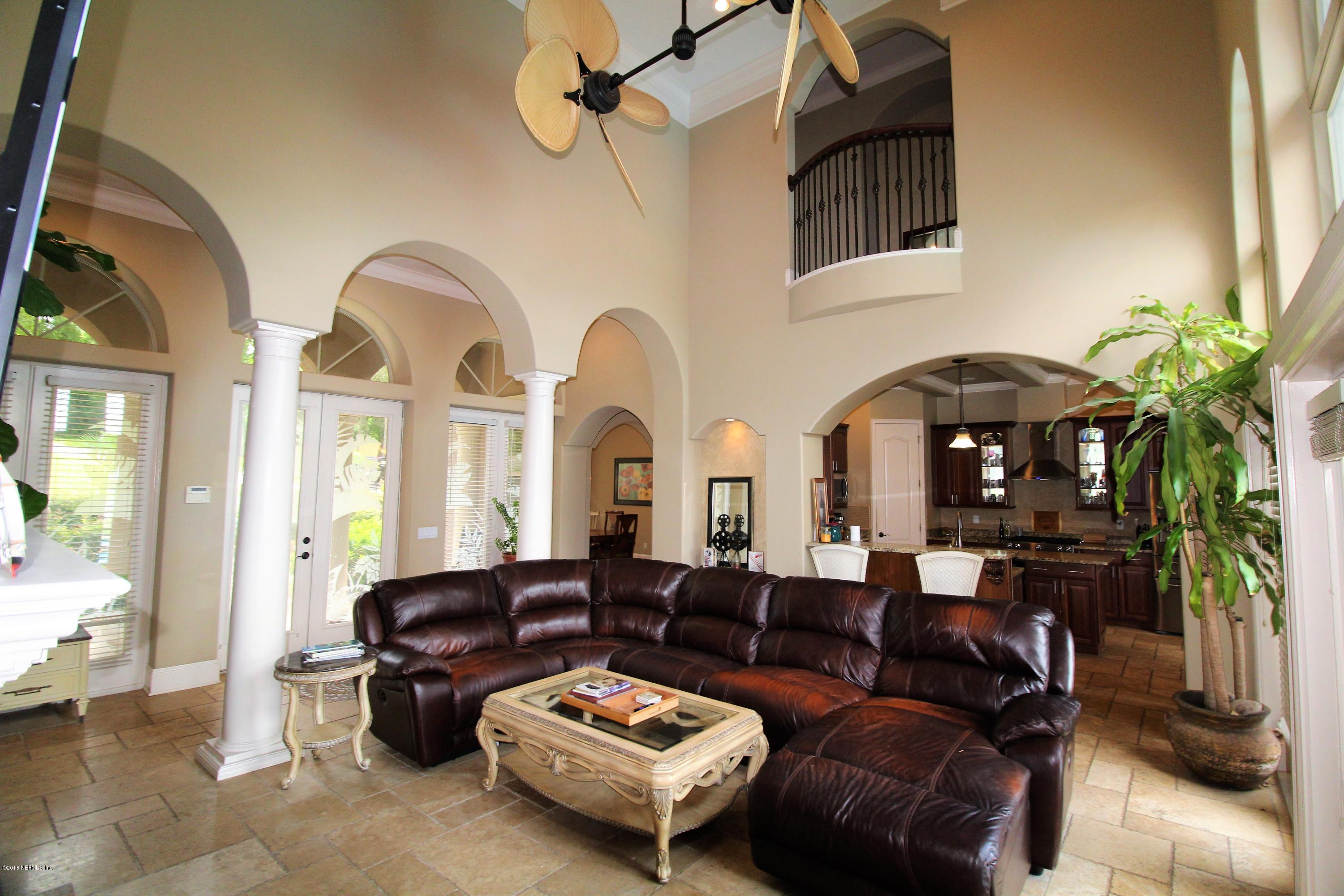 6471 Immokalee Road Keystone Heights, FL 32656 - Photo 11 of 103 a living room with furniture a chandelier and a fireplace