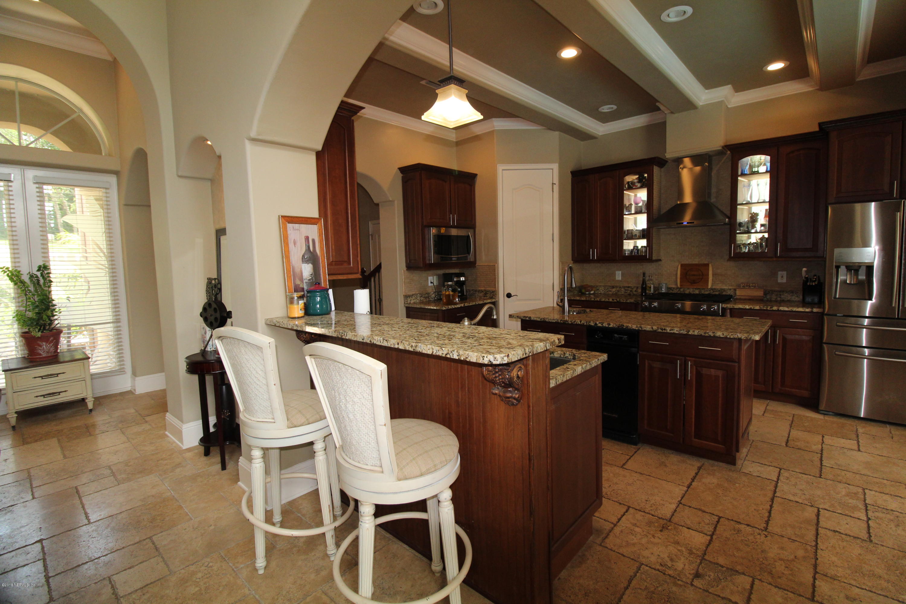 6471 Immokalee Road Keystone Heights, FL 32656 - Photo 20 of 103 a kitchen with a sink and a stove top oven with wooden floor