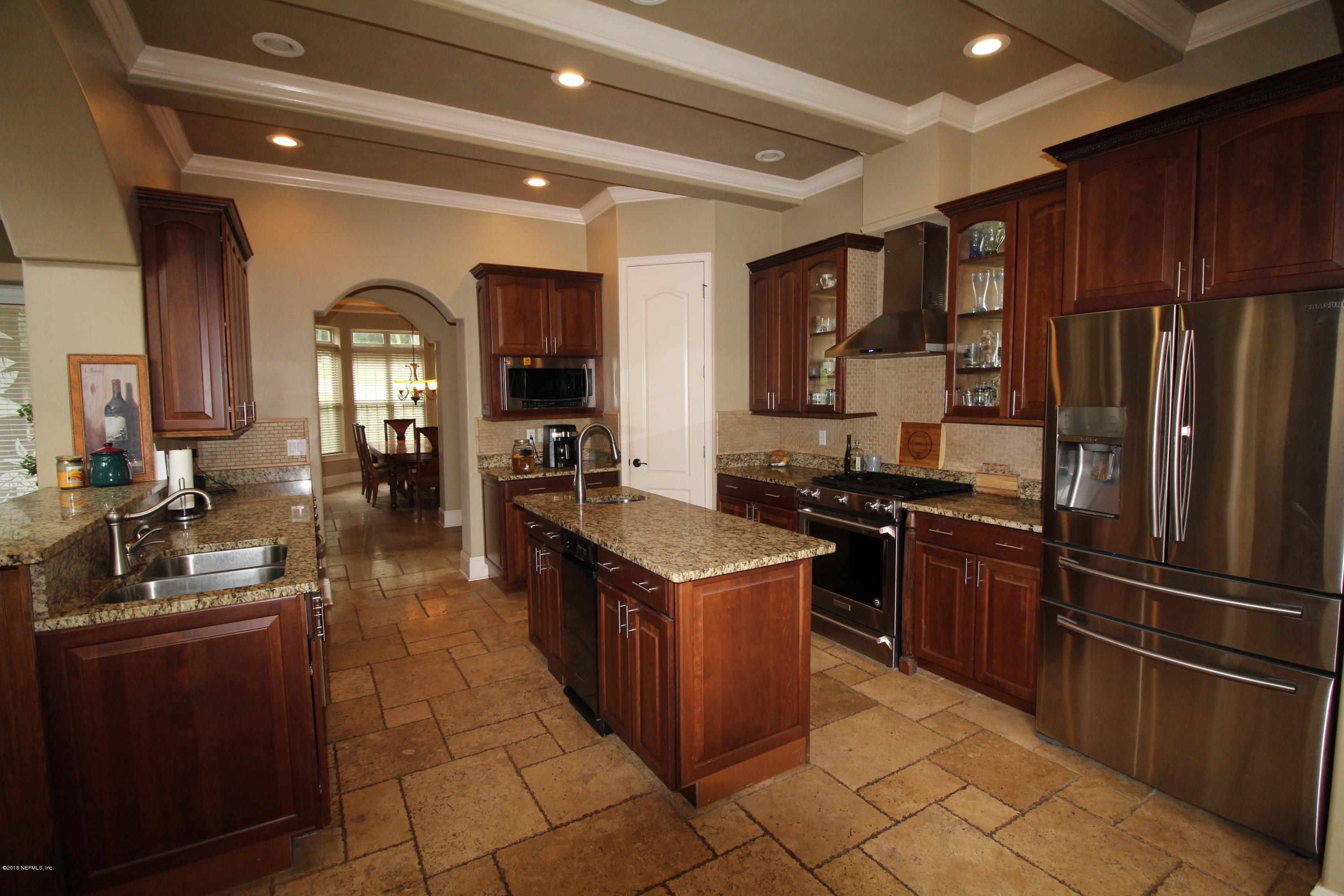 6471 Immokalee Road Keystone Heights, FL 32656 - Photo 24 of 103 a kitchen with stainless steel appliances granite countertop a stove a refrigerator and a refrigerator