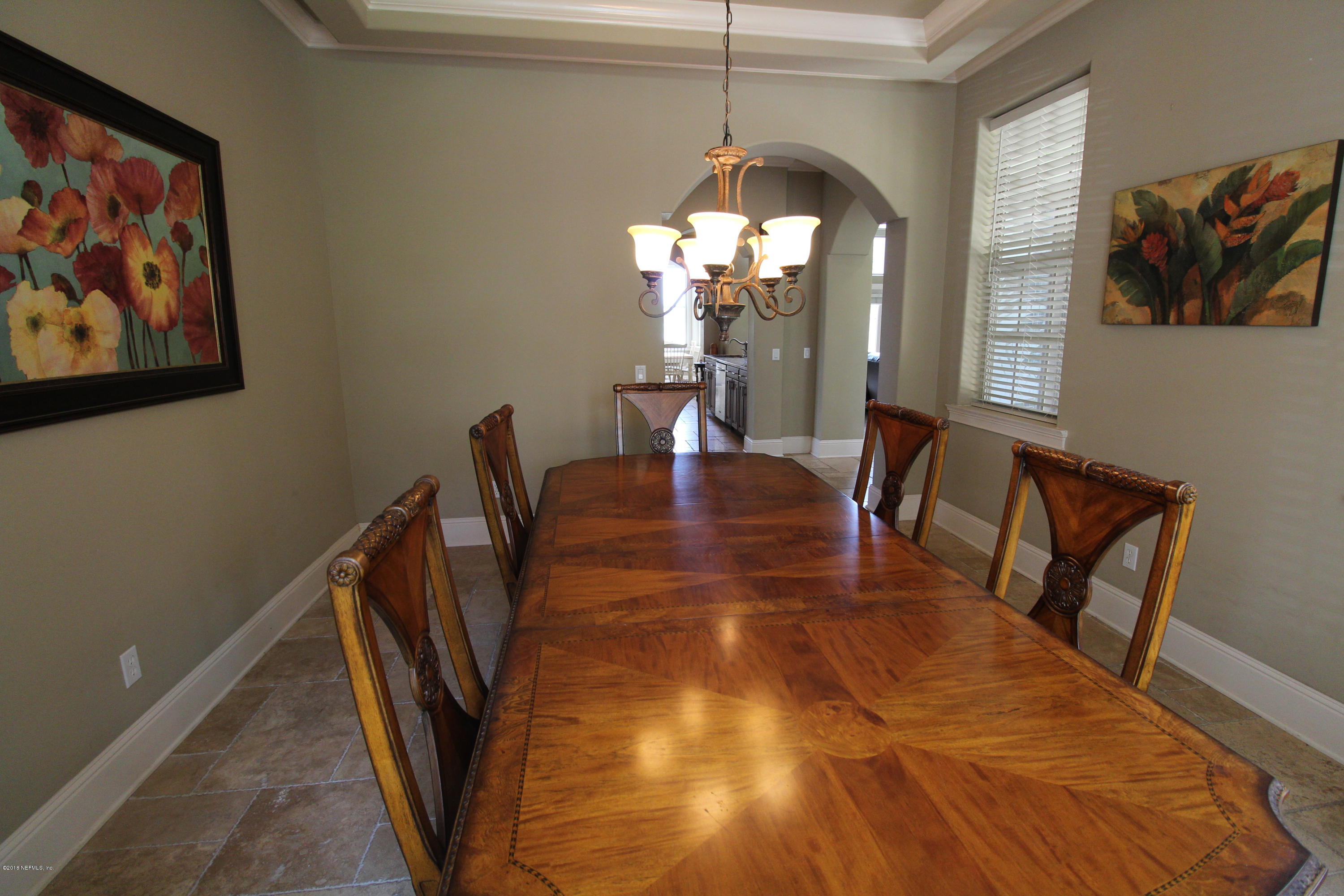 6471 Immokalee Road Keystone Heights, FL 32656 - Photo 33 of 103 a view of a dining room with furniture and chandelier
