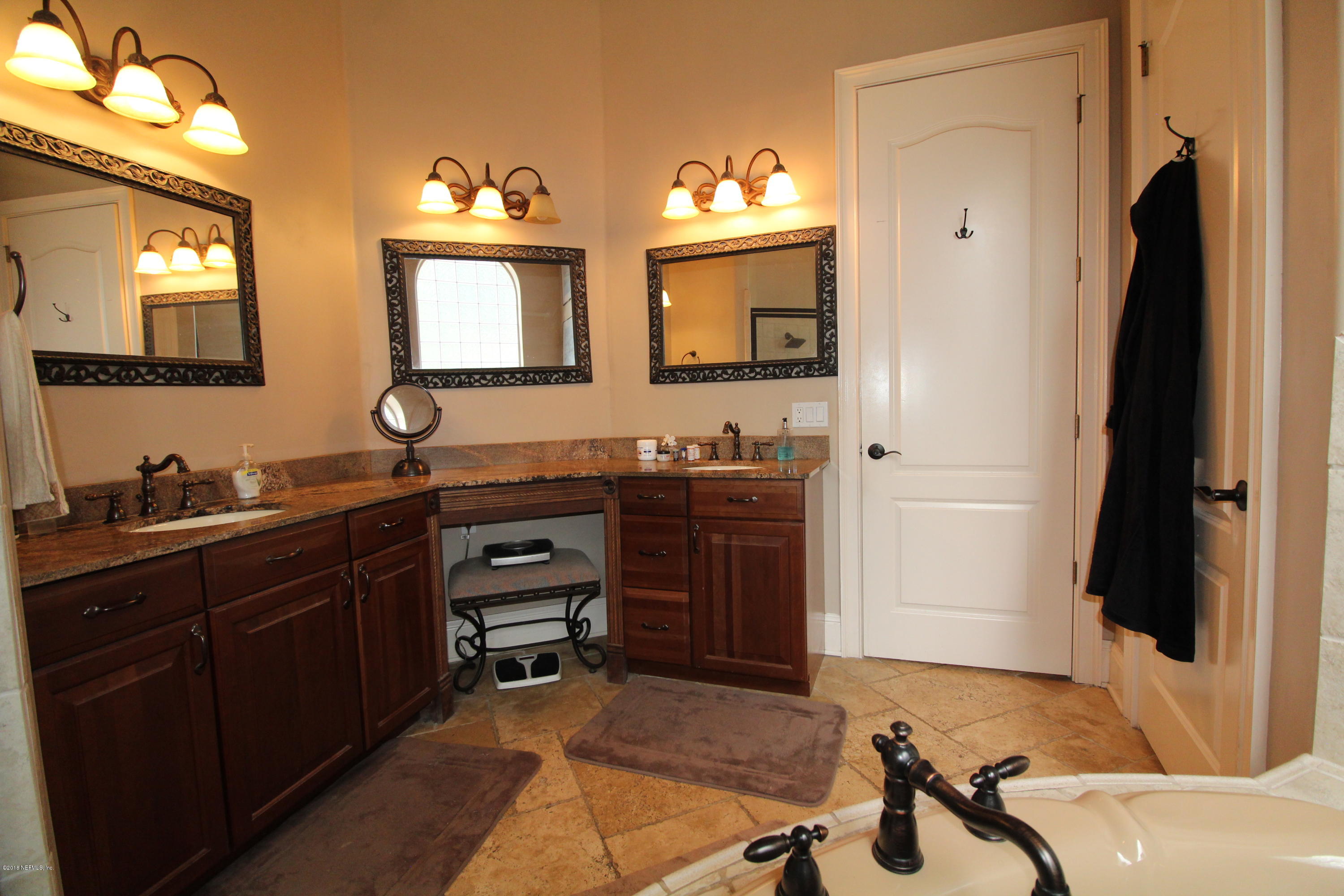 6471 Immokalee Road Keystone Heights, FL 32656 - Photo 41 of 103 a bathroom with a sink double vanity and a mirror