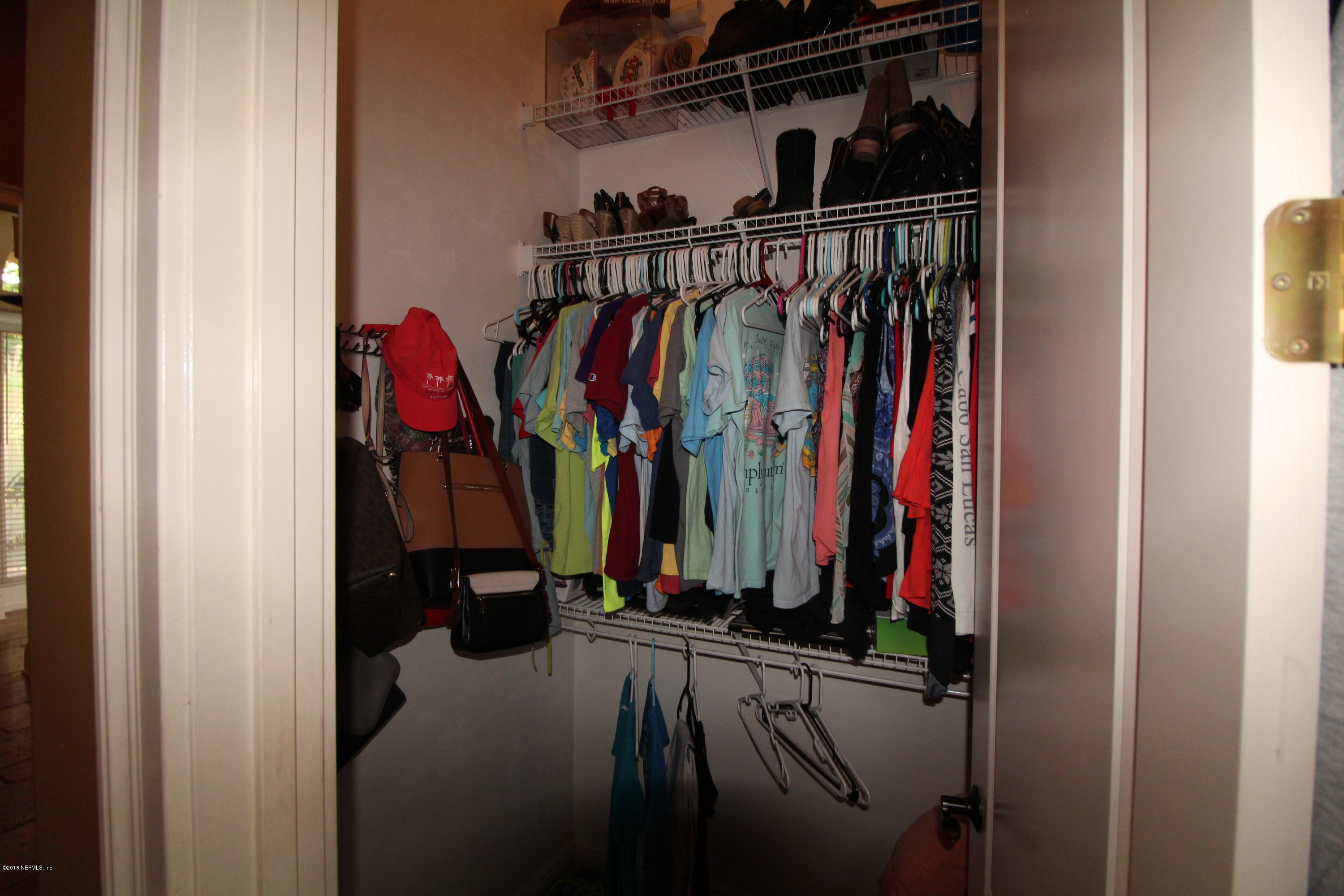 6471 Immokalee Road Keystone Heights, FL 32656 - Photo 44 of 103 a view of walk in closet with clothes