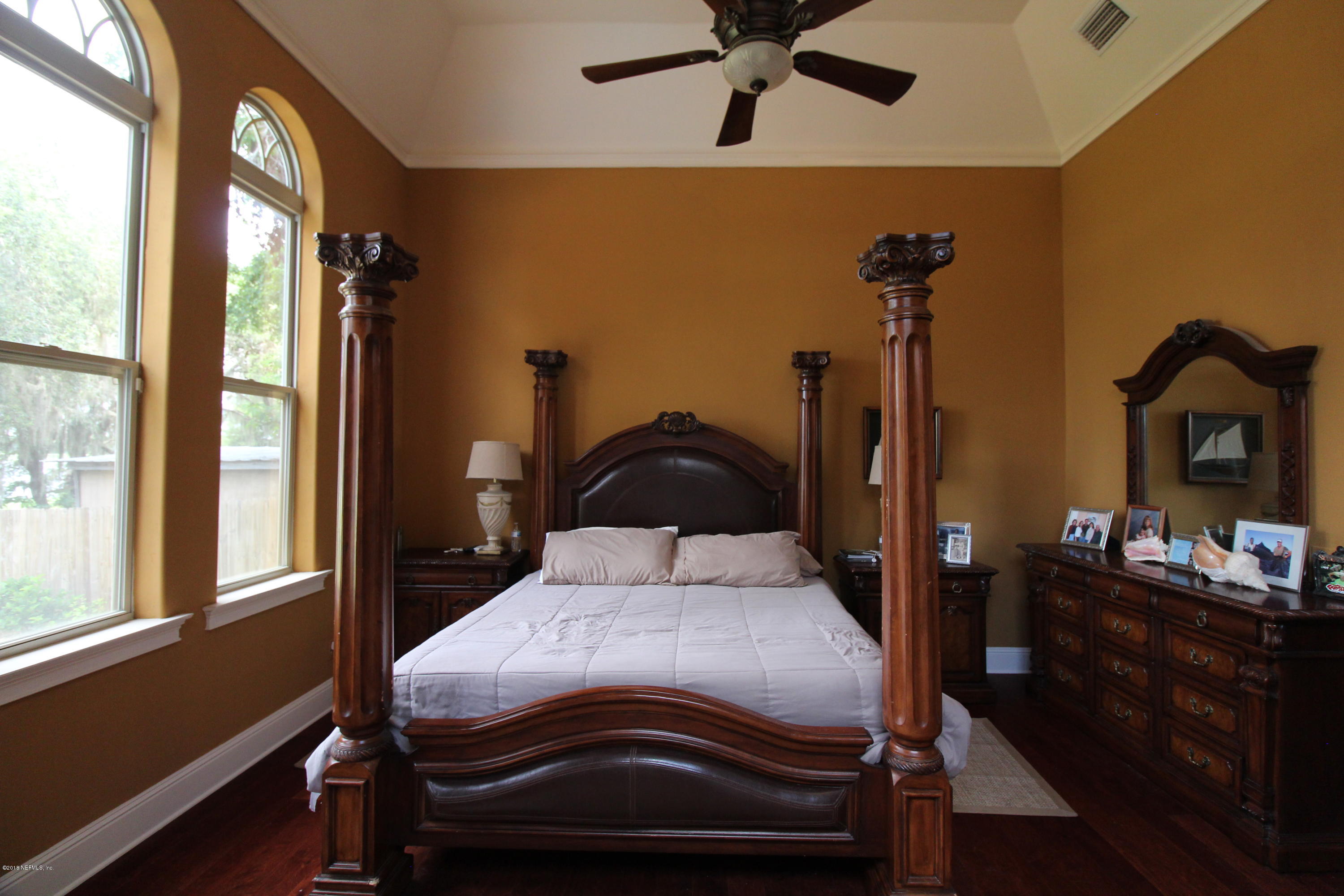 6471 Immokalee Road Keystone Heights, FL 32656 - Photo 47 of 103 a bedroom with a bed and large windows
