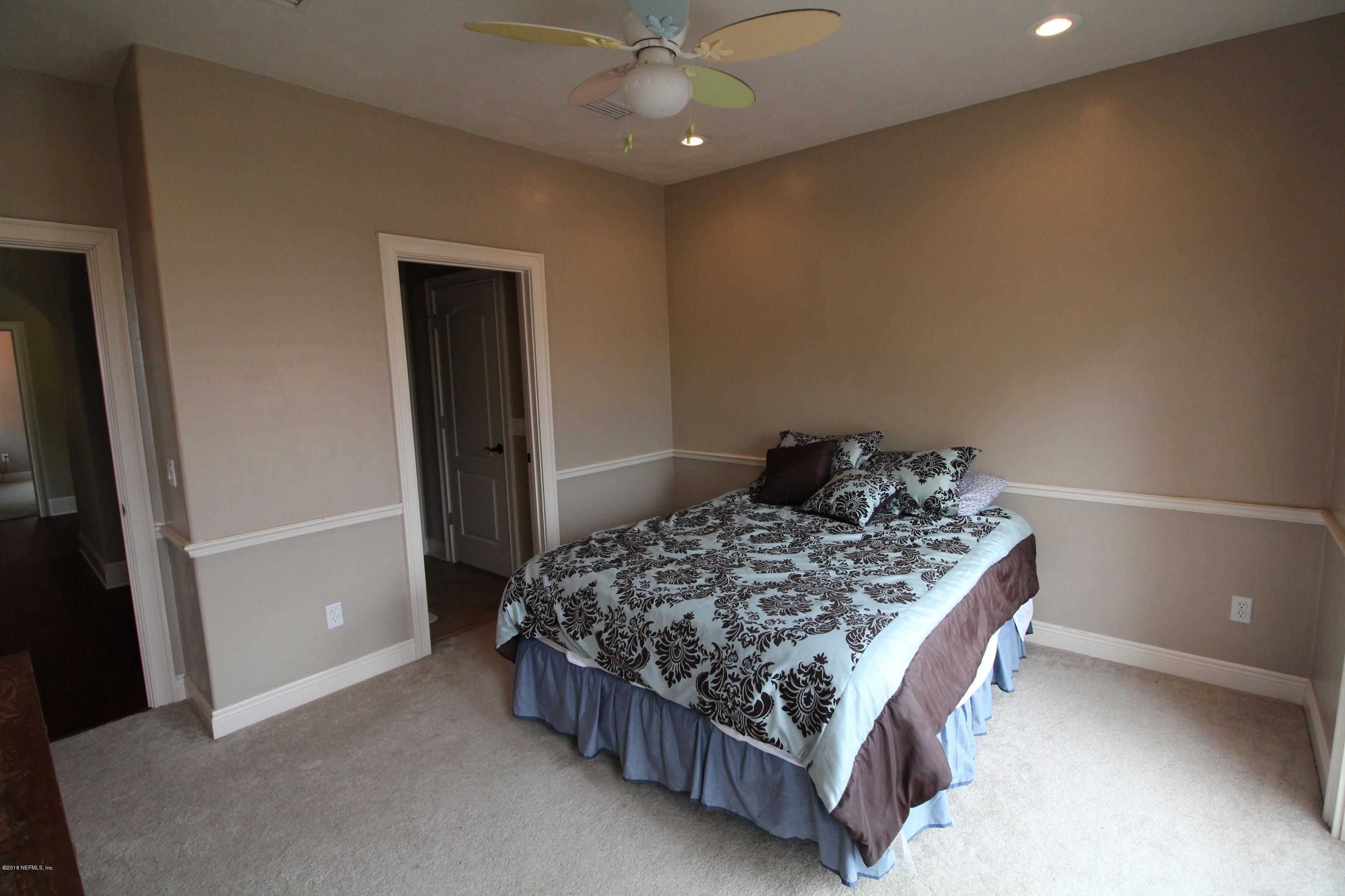 6471 Immokalee Road Keystone Heights, FL 32656 - Photo 58 of 103 a bed sitting in a bedroom next to a window