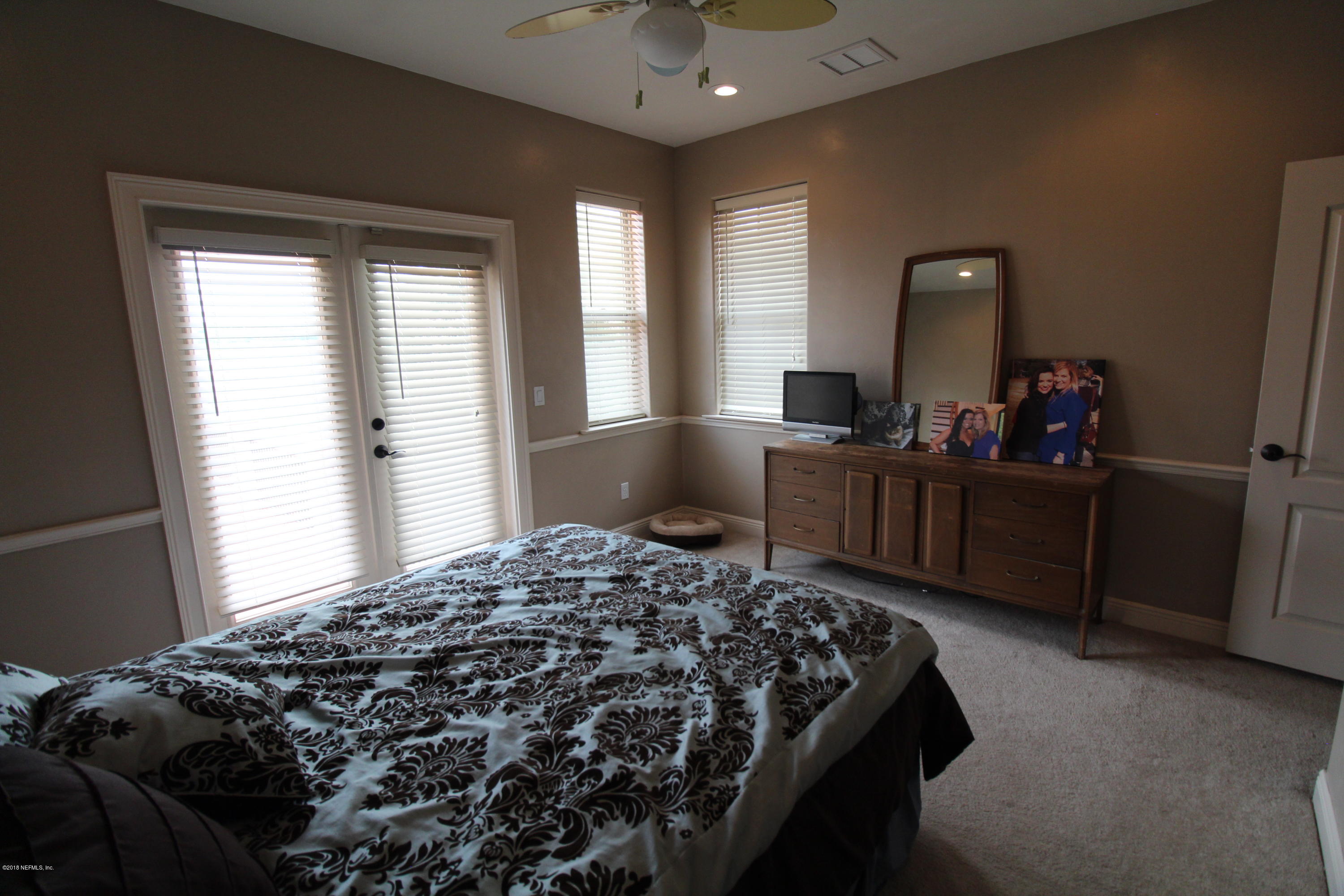 6471 Immokalee Road Keystone Heights, FL 32656 - Photo 60 of 103 a bed sitting in a bedroom next to a window