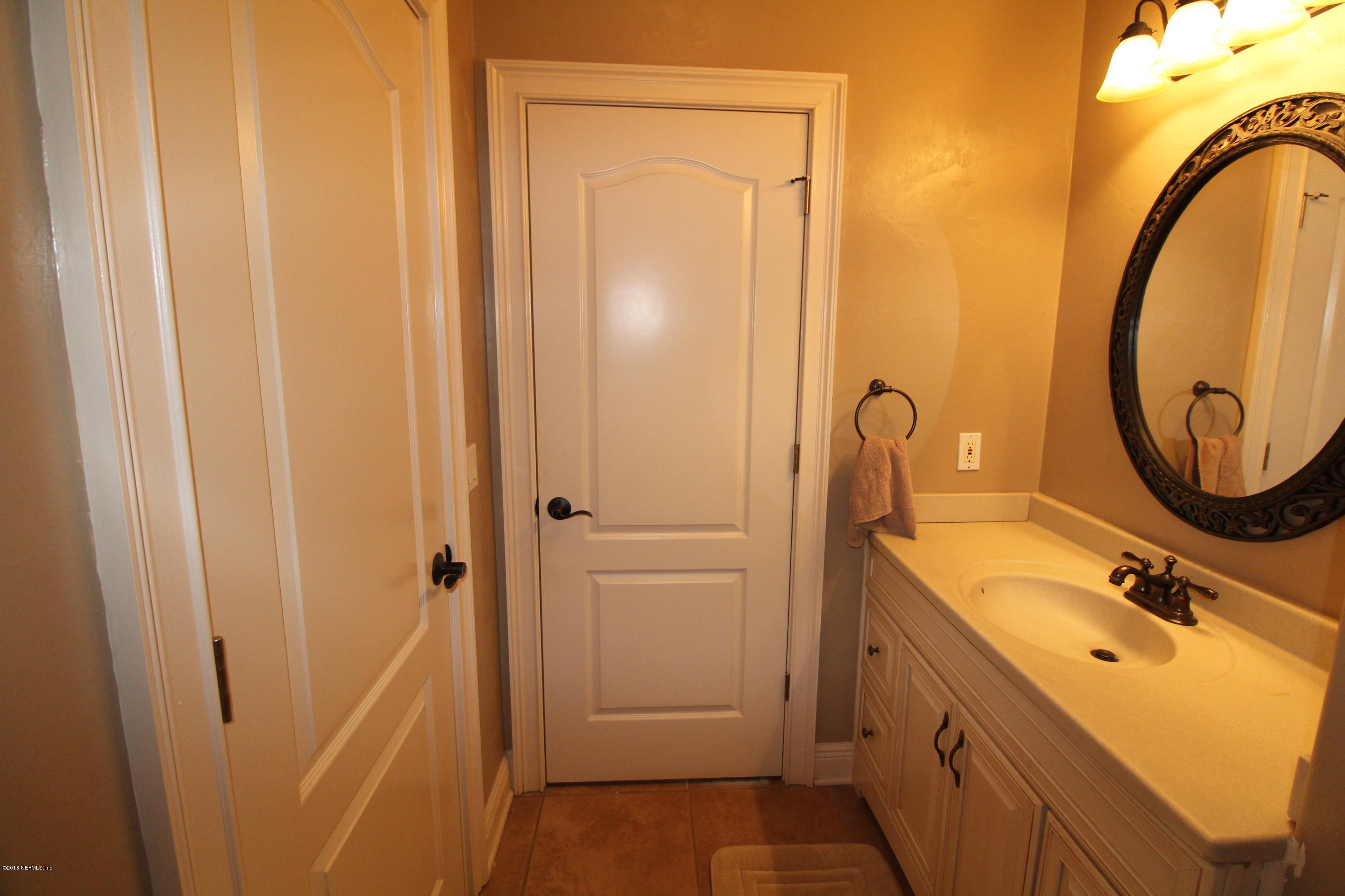 6471 Immokalee Road Keystone Heights, FL 32656 - Photo 61 of 103 a bathroom with a sink and a mirror