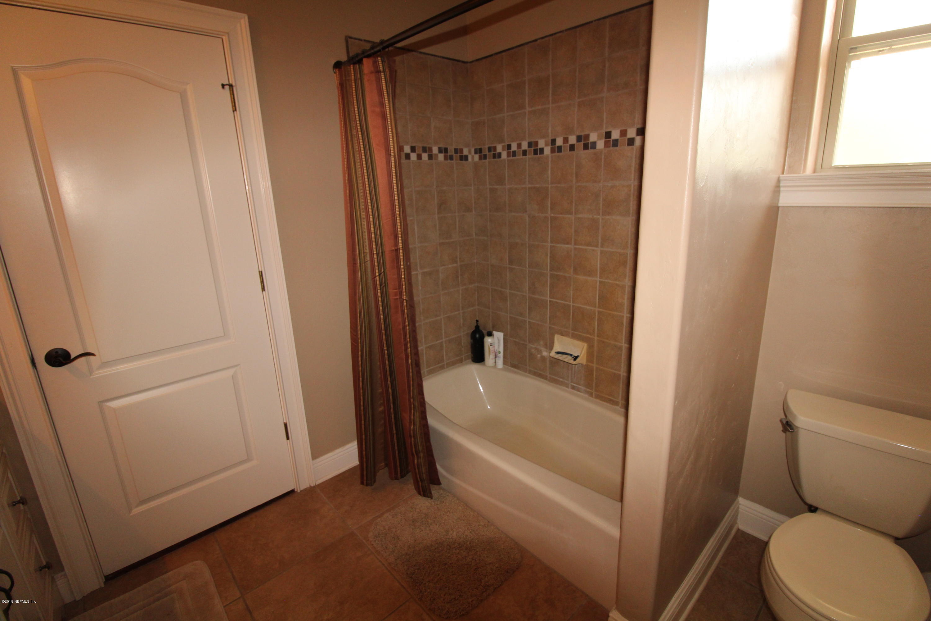 6471 Immokalee Road Keystone Heights, FL 32656 - Photo 66 of 103 a bathroom with a granite countertop sink toilet and shower