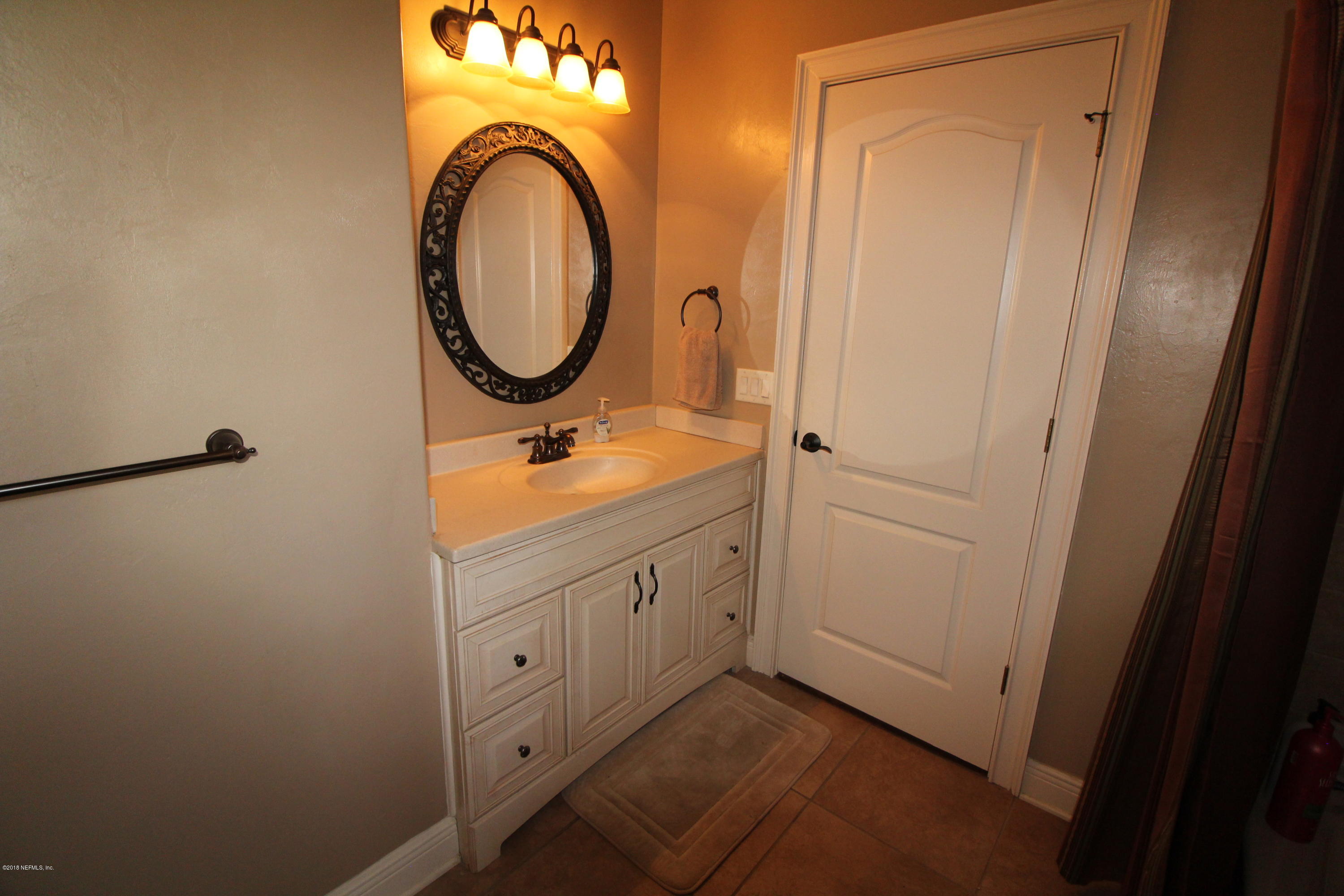 6471 Immokalee Road Keystone Heights, FL 32656 - Photo 67 of 103 a bathroom with a granite countertop sink and a mirror