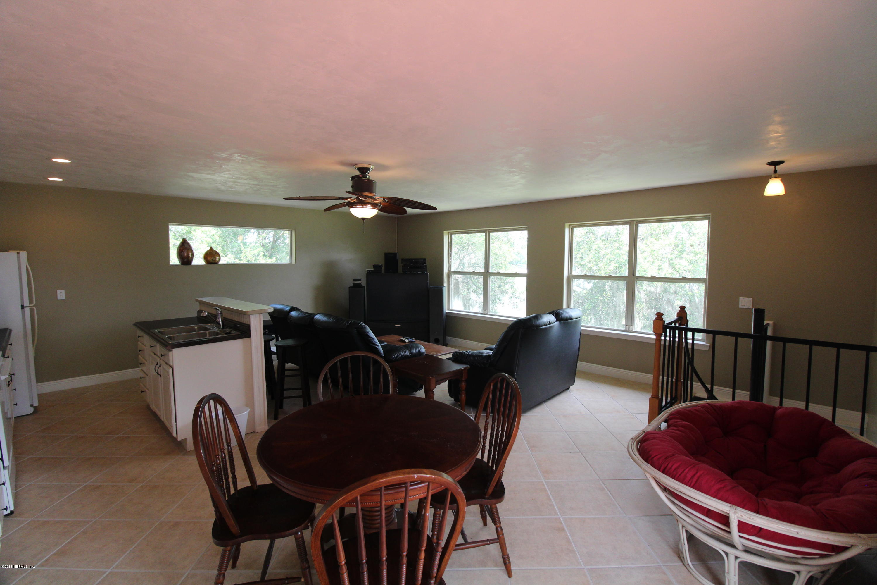6471 Immokalee Road Keystone Heights, FL 32656 - Photo 75 of 103 a living room with furniture a flat screen tv and a window
