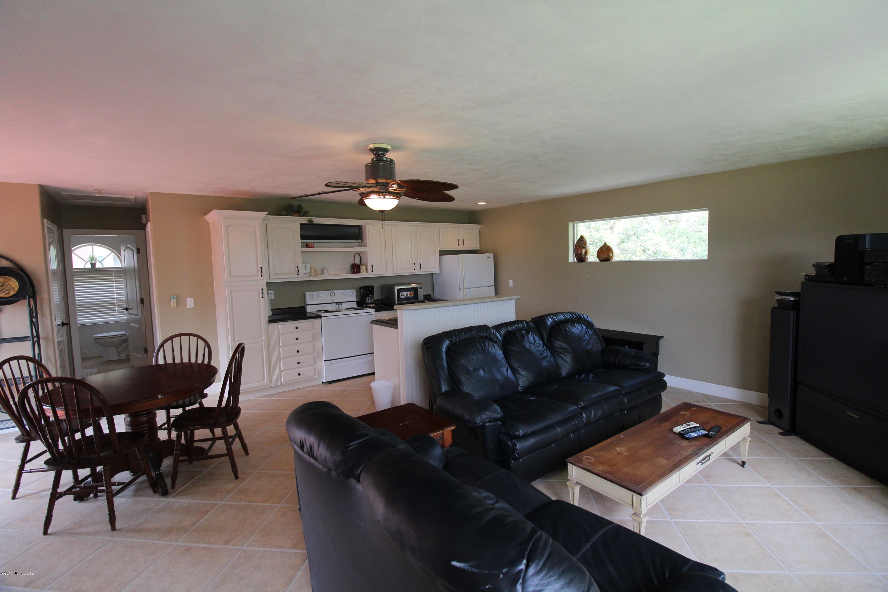 6471 Immokalee Road Keystone Heights, FL 32656 - Photo 76 of 103 a living room with furniture and a flat screen tv