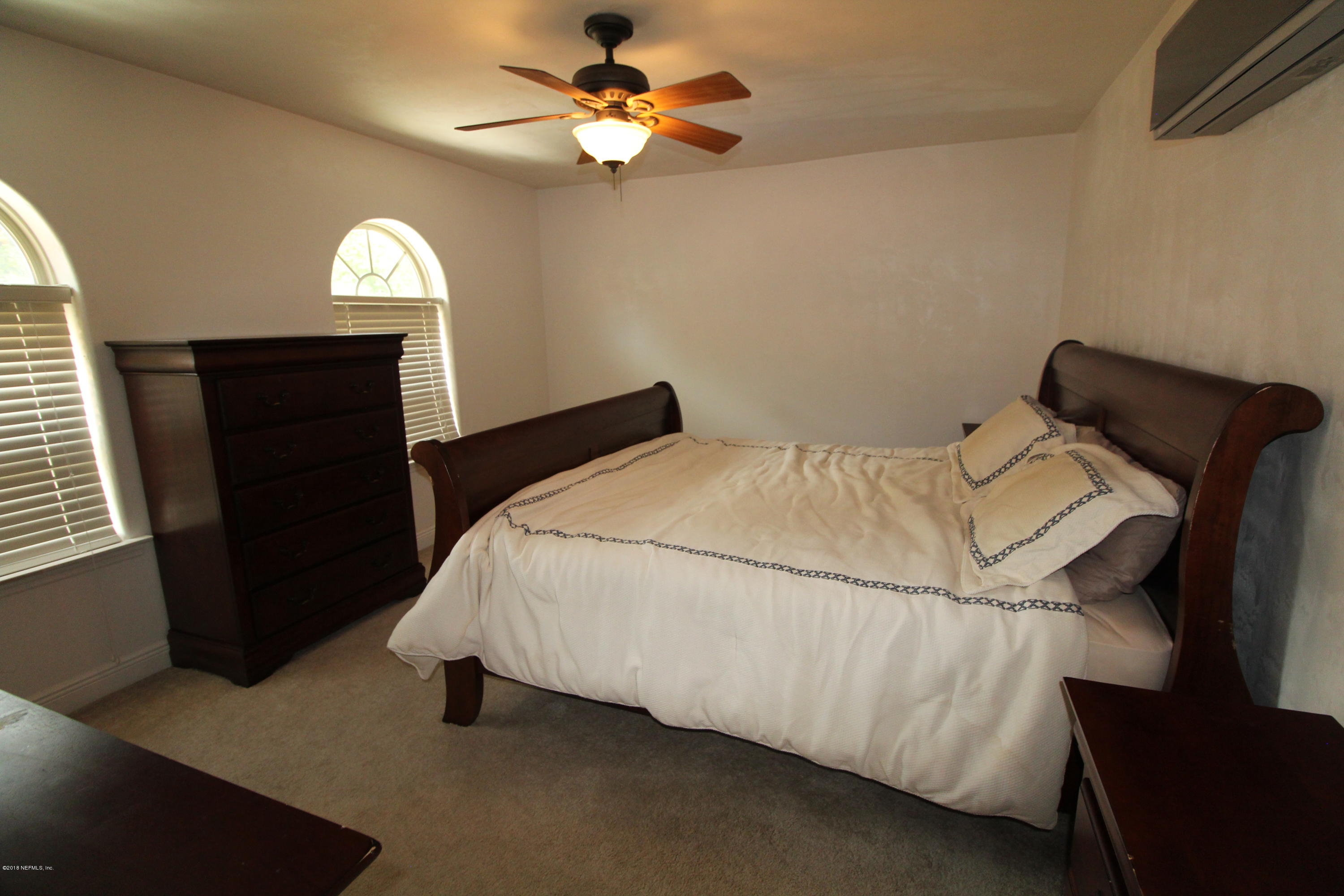 6471 Immokalee Road Keystone Heights, FL 32656 - Photo 79 of 103 a bedroom with a bed and a ceiling fan