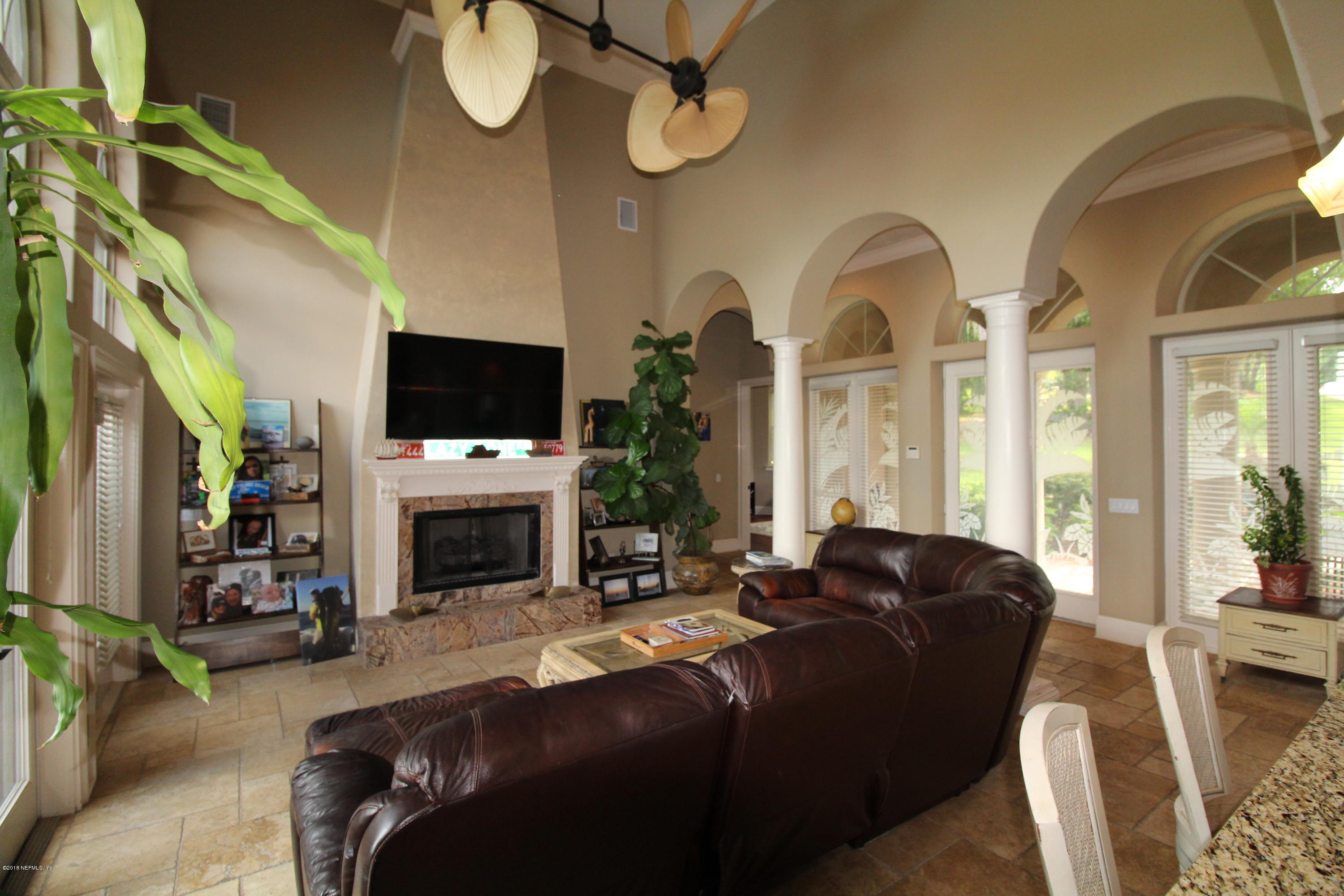 6471 Immokalee Road Keystone Heights, FL 32656 - Photo 8 of 103 a living room with furniture a fireplace and a flat screen tv