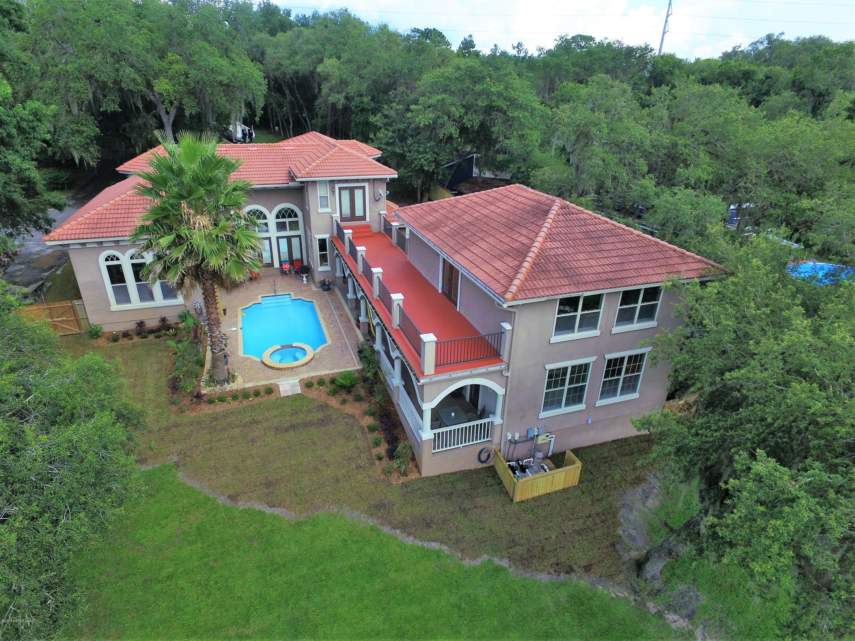6471 Immokalee Road Keystone Heights, FL 32656 - Photo 84 of 103 a aerial view of a house with swimming pool and garden