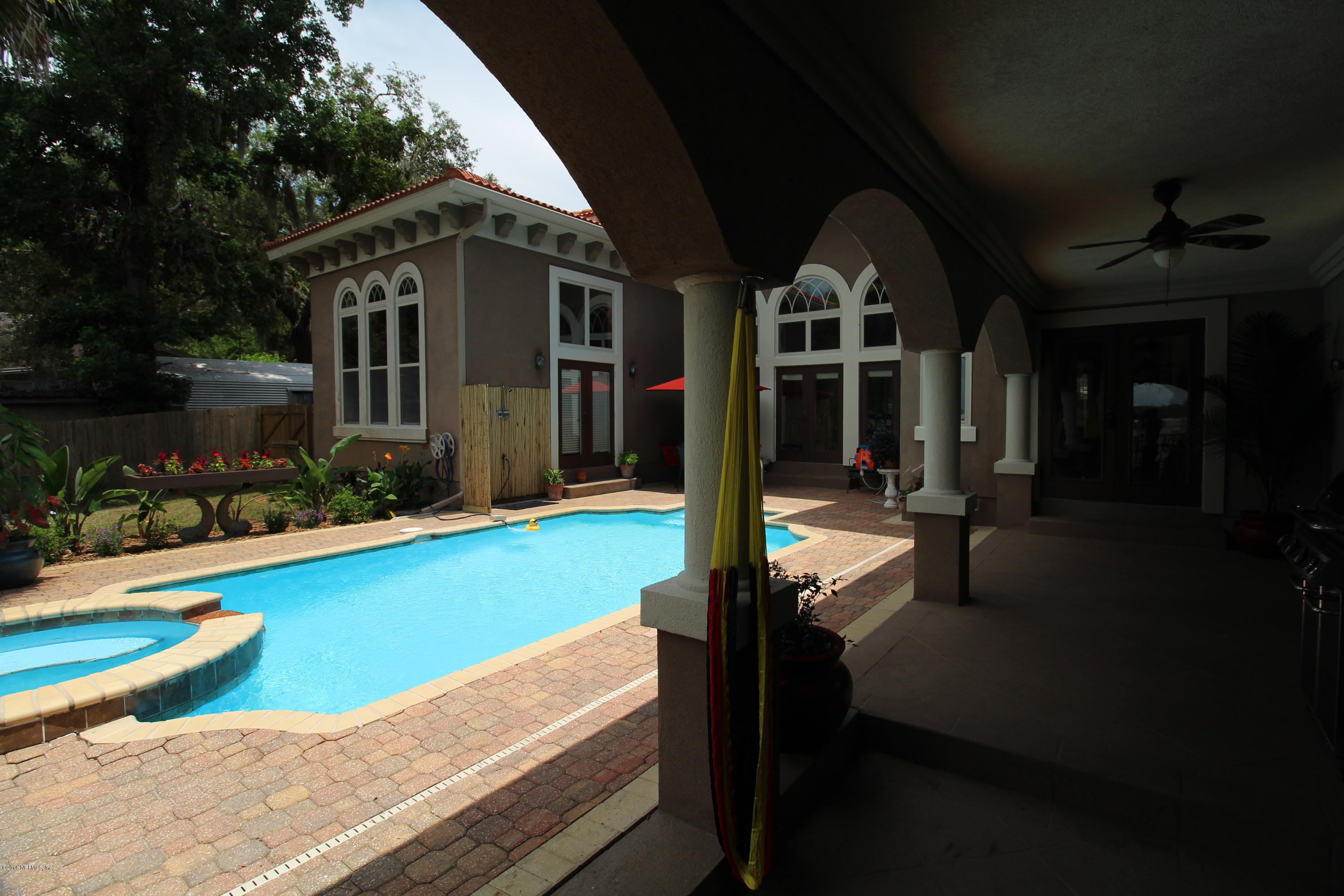 6471 Immokalee Road Keystone Heights, FL 32656 - Photo 99 of 103 a front view of a house with swimming pool next to a yard
