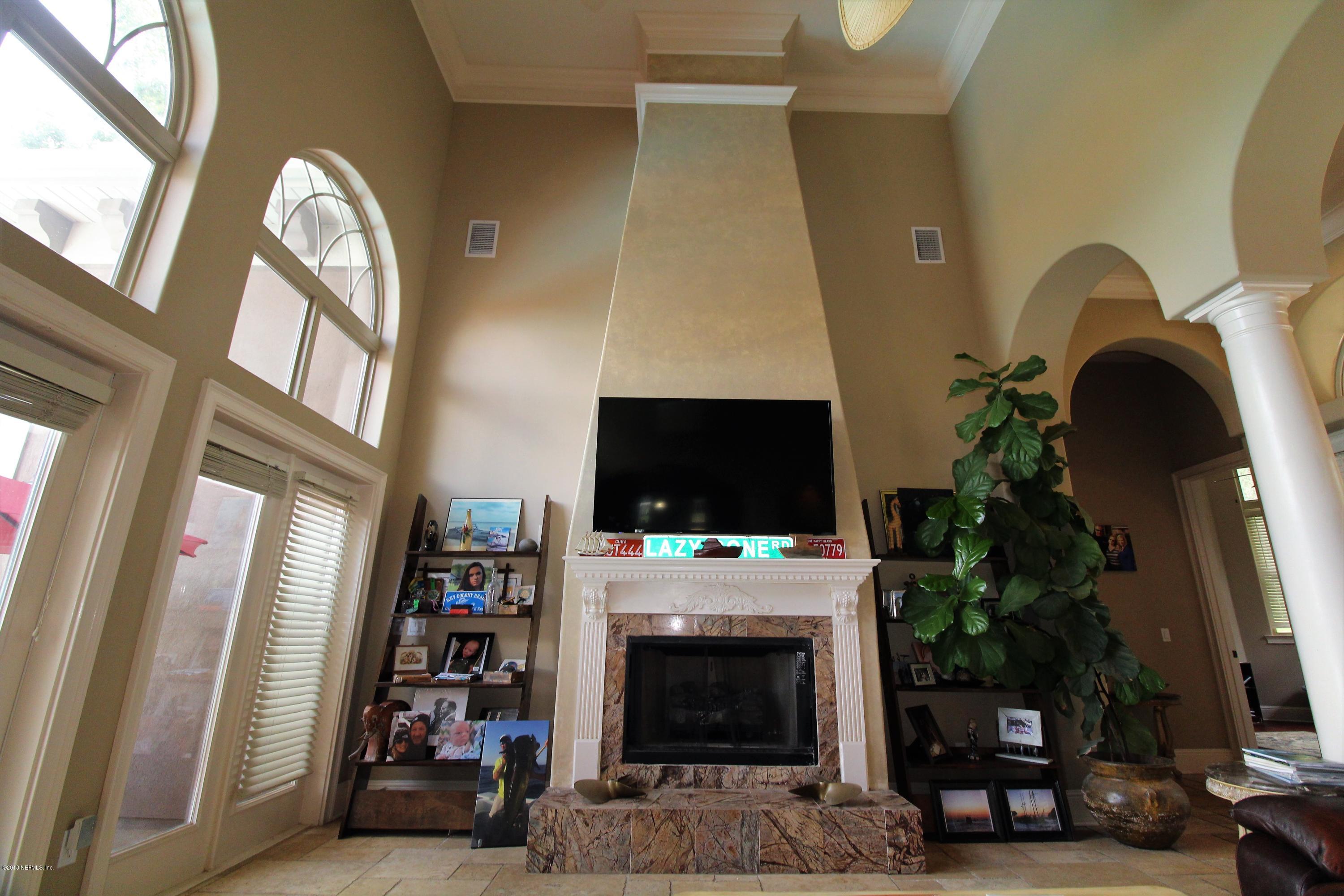 6471 Immokalee Road Keystone Heights, FL 32656 - Photo 10 of 103 a living room with furniture a flat screen tv and a fireplace