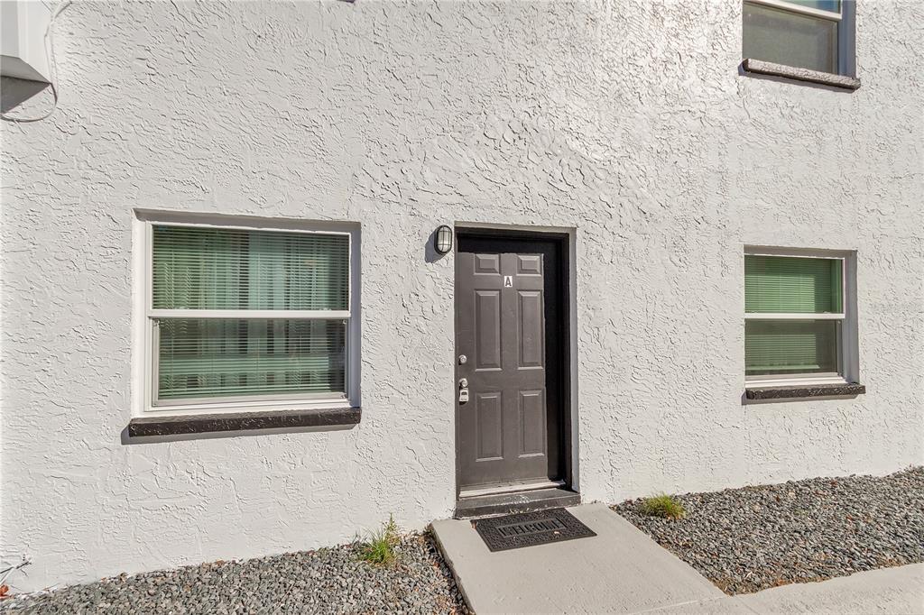 4913 East Temple Heights Road, Unit A Tampa, FL 33617 - Photo 14 of 41 a front view of a house with a yard