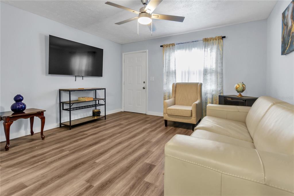 4913 East Temple Heights Road, Unit A Tampa, FL 33617 - Photo 16 of 41 a living room with furniture and a flat screen tv