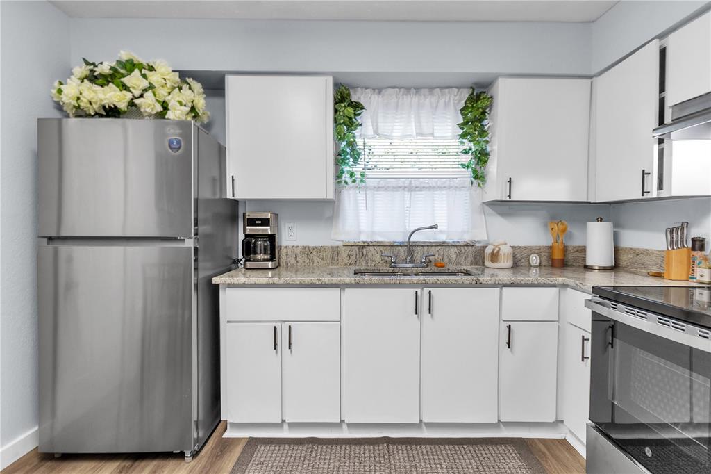 4913 East Temple Heights Road, Unit A Tampa, FL 33617 - Photo 18 of 41 a kitchen with stainless steel appliances granite countertop a refrigerator sink and stove