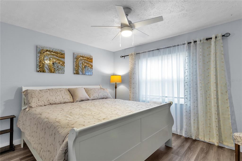 4913 East Temple Heights Road, Unit A Tampa, FL 33617 - Photo 20 of 41 a bedroom with a bed and a chandelier