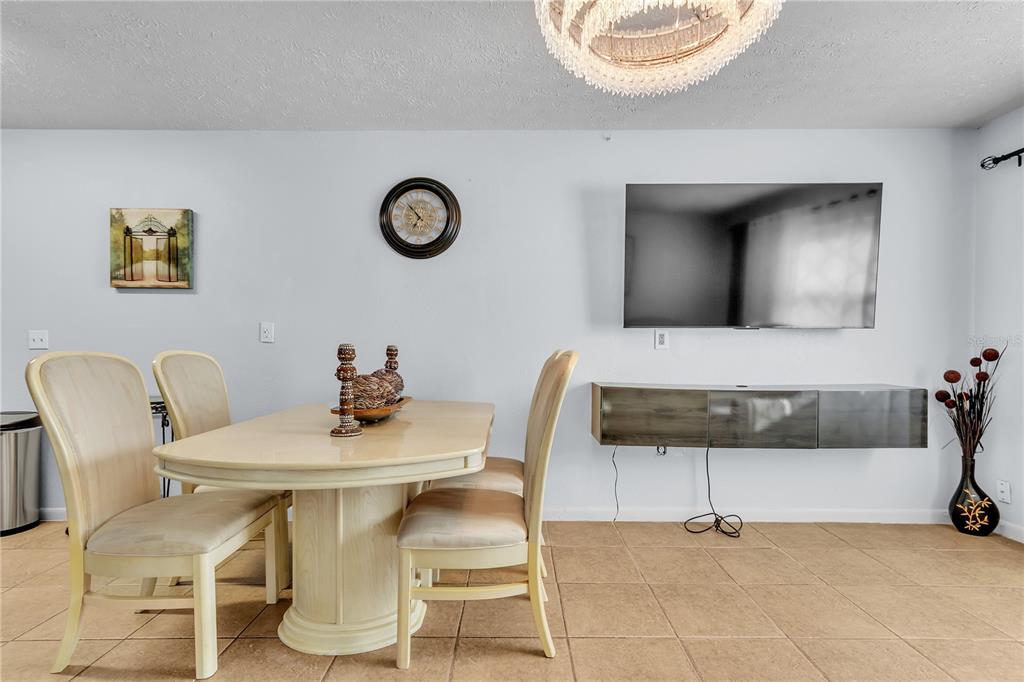 4913 East Temple Heights Road, Unit A Tampa, FL 33617 - Photo 27 of 41 a view of a dining room with furniture and a table