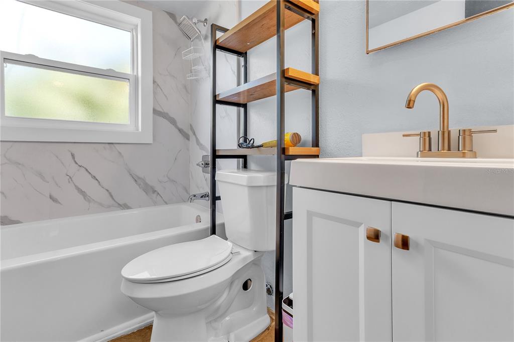 4913 East Temple Heights Road, Unit A Tampa, FL 33617 - Photo 32 of 41 a bathroom with a sink a toilet and shower