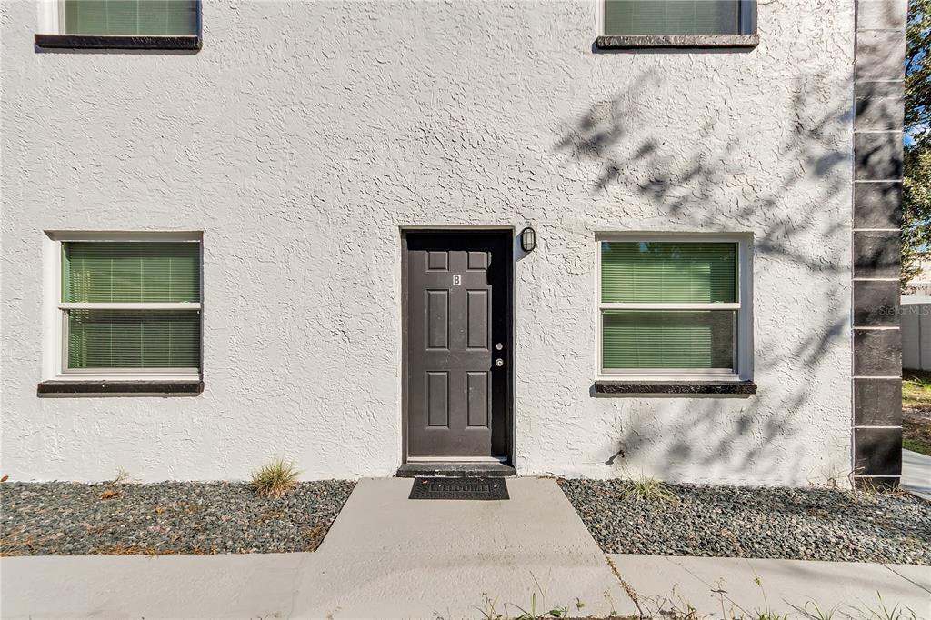4913 East Temple Heights Road, Unit A Tampa, FL 33617 - Photo 34 of 41 a front view of a house with a yard