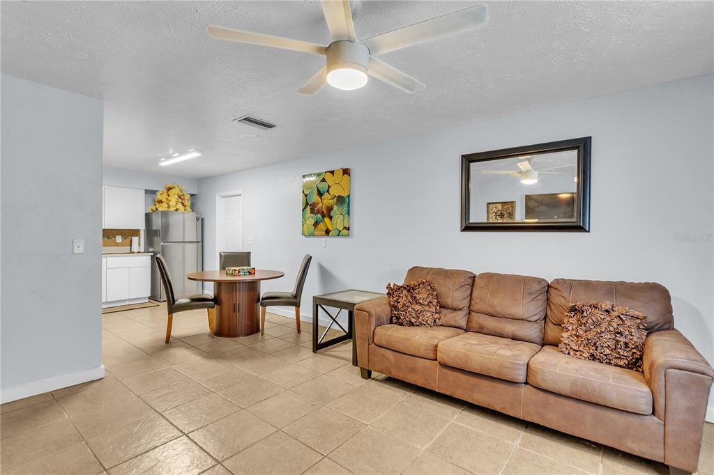 4913 East Temple Heights Road, Unit A Tampa, FL 33617 - Photo 35 of 41 a living room with furniture and painting on the wall