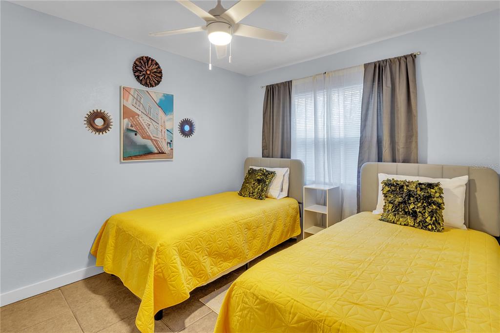 4913 East Temple Heights Road, Unit A Tampa, FL 33617 - Photo 40 of 41 a bedroom with bed and window