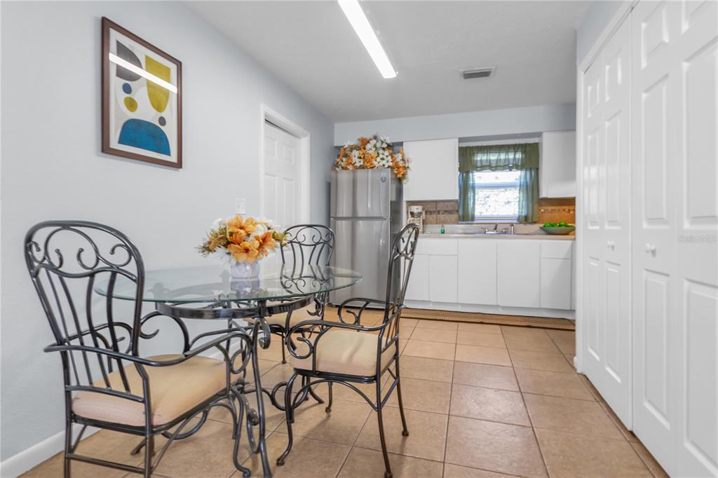 4913 East Temple Heights Road, Unit A Tampa, FL 33617 - Photo 7 of 41 a dining room with furniture and window