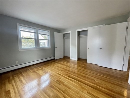 59 Desoto Road, Unit 2 Boston, MA 02132 - Photo 8 of 13 a view of an empty room with wooden floor and a window