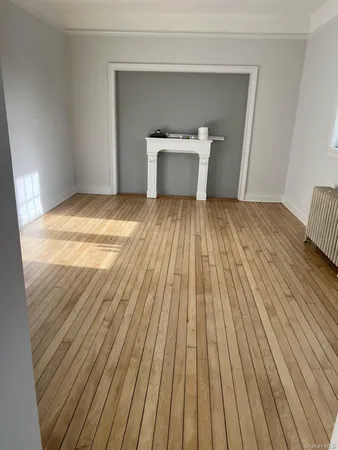 a view of a room with wooden floor and gate