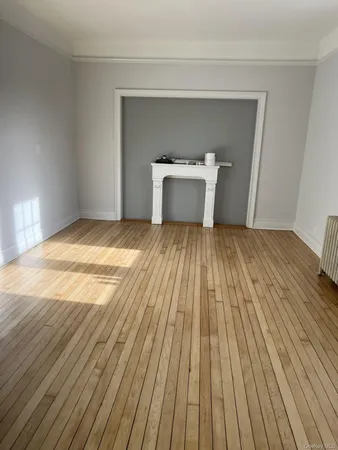 a view of a room with wooden floor and white cabinet