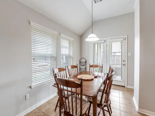 a dining room with furniture and window