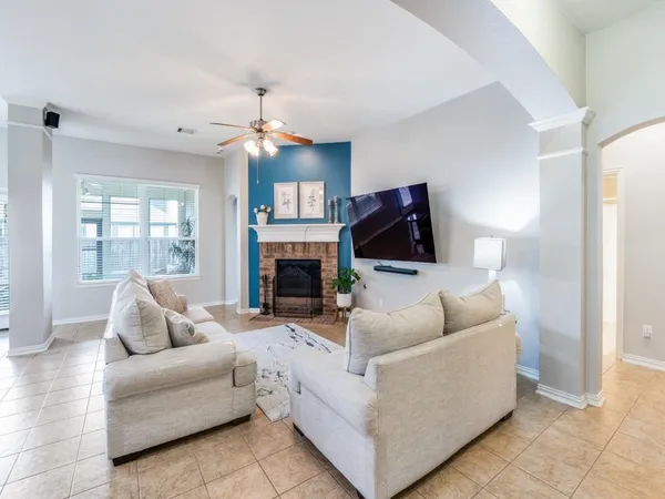 a living room with furniture a fireplace and a flat screen tv