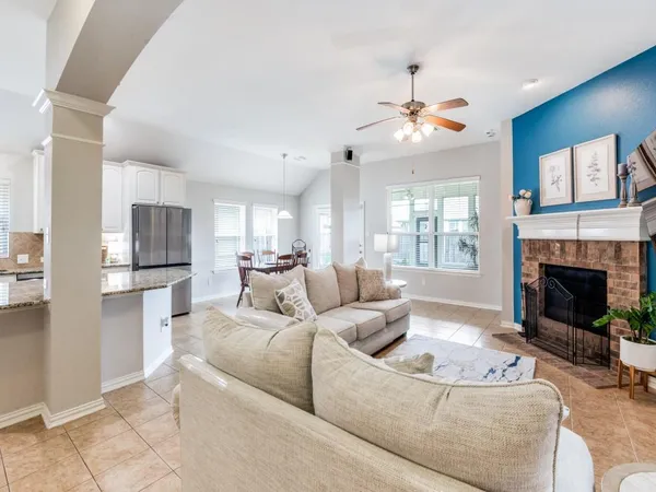 a living room with furniture a fireplace and a flat screen tv