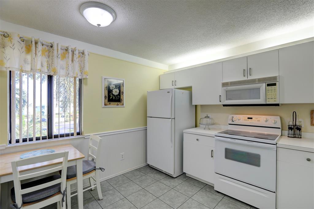 9635 Riverside Drive Sebastian, FL 32958 - Photo 22 of 58 a kitchen with a stove and a refrigerator