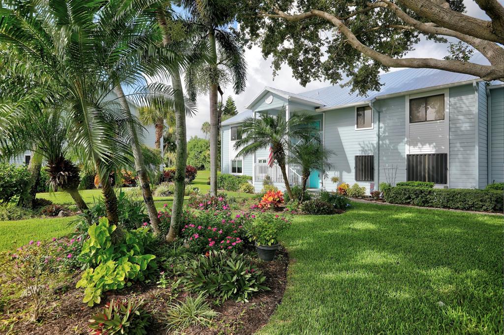 9635 Riverside Drive Sebastian, FL 32958 - Photo 33 of 58 a front view of a house with a yard and potted plants
