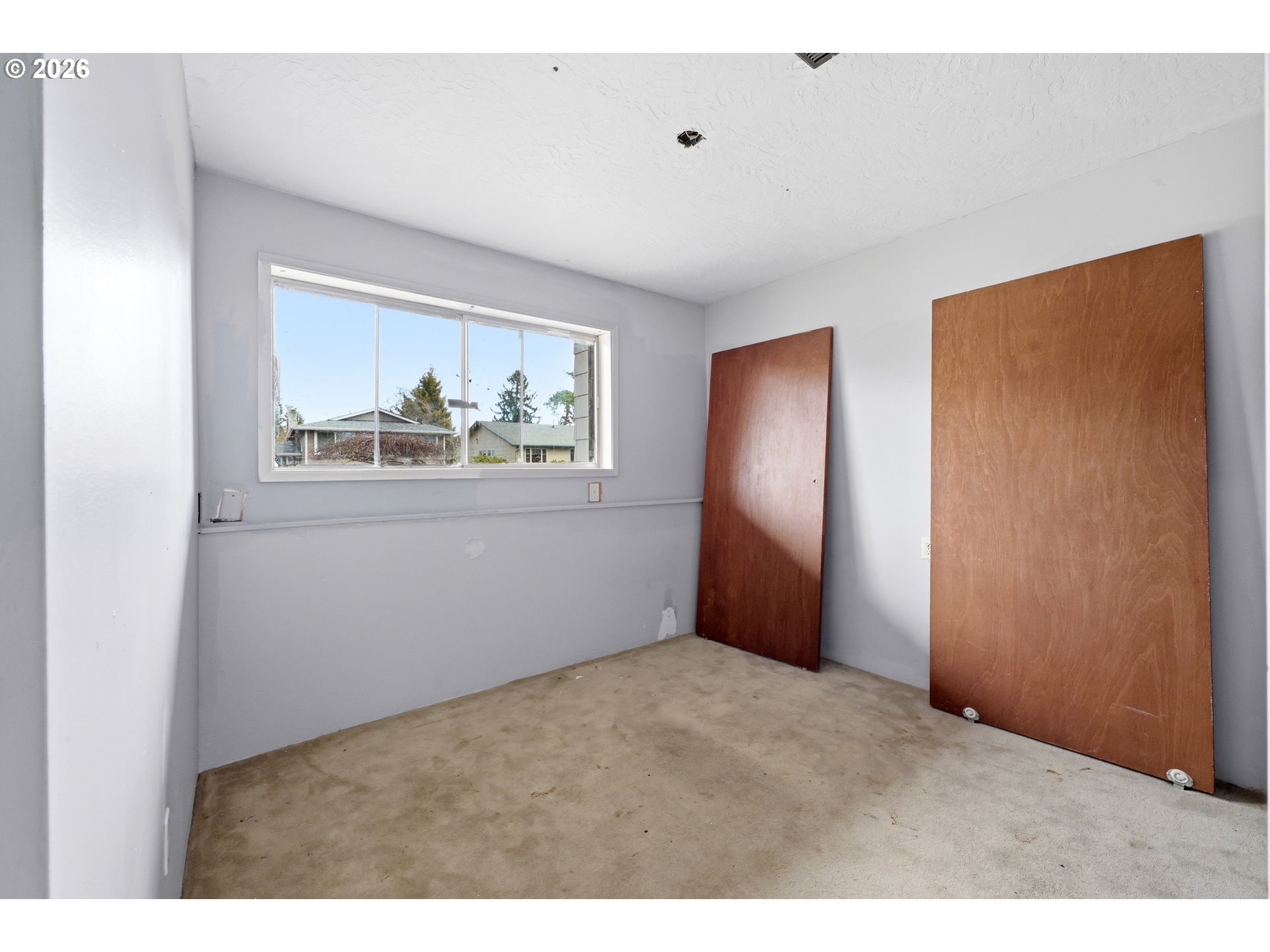 205 Southeast Olvera Avenue Gresham, OR 97080 - Photo 11 of 13 a view of an empty room with wooden floor and a window