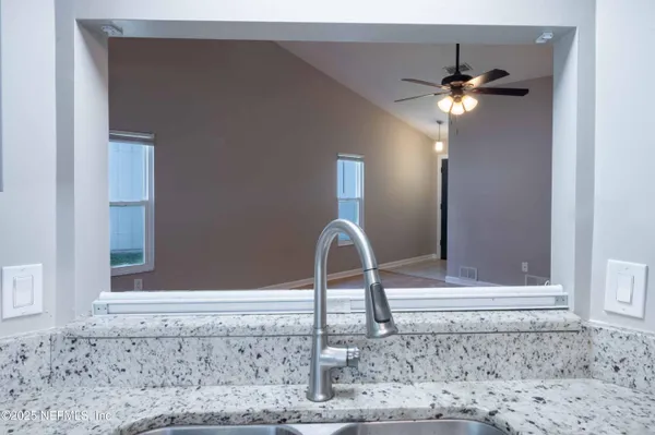 a close view of a faucet a sink and a window