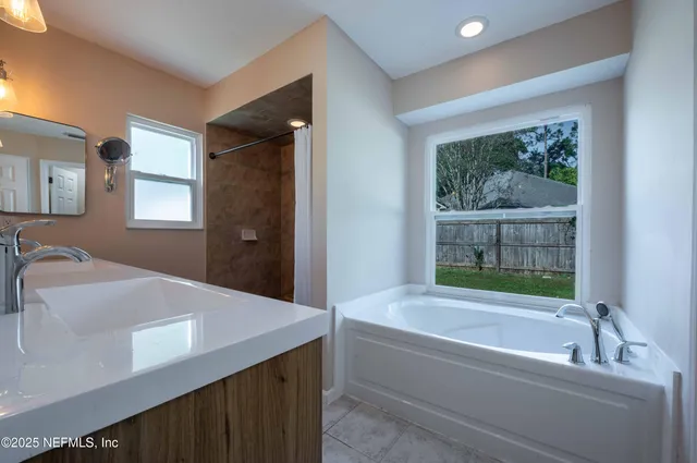 a bathroom with a bathtub and a sink