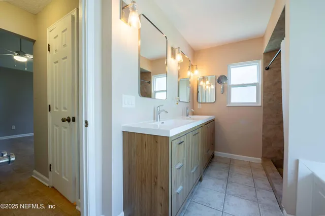 a bathroom with a double vanity sink and mirror