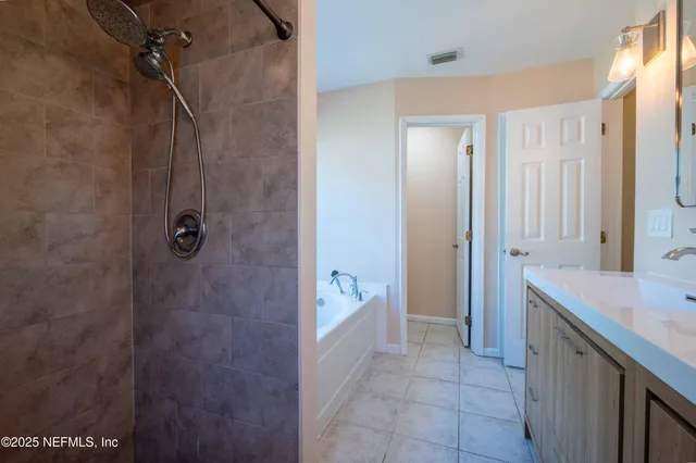 a bathroom with a shower and a sink