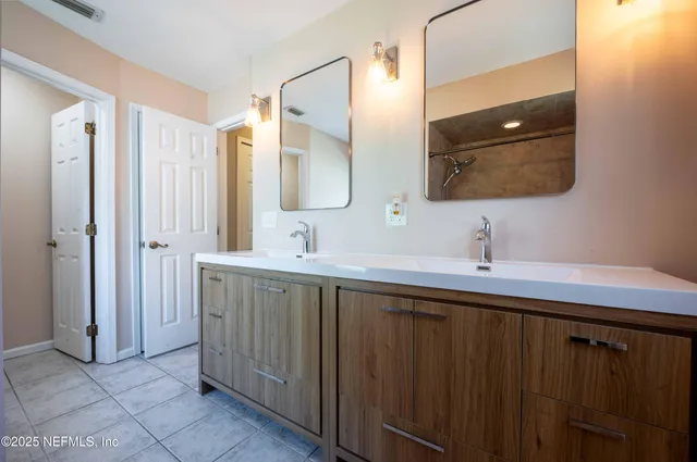a bathroom with a double vanity sink and mirror