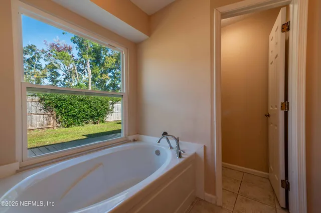 a bathroom with a bathtub and shower