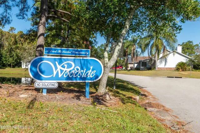 a view of outdoor space with sign board and lake view