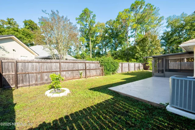 a view of a backyard with a table and chairs