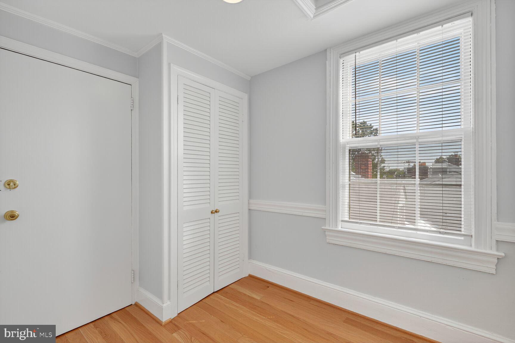 1363 28th Street Northwest, Unit 3 Washington, DC 20007 - Photo 11 of 13 a view of an empty room with wooden floor and a window