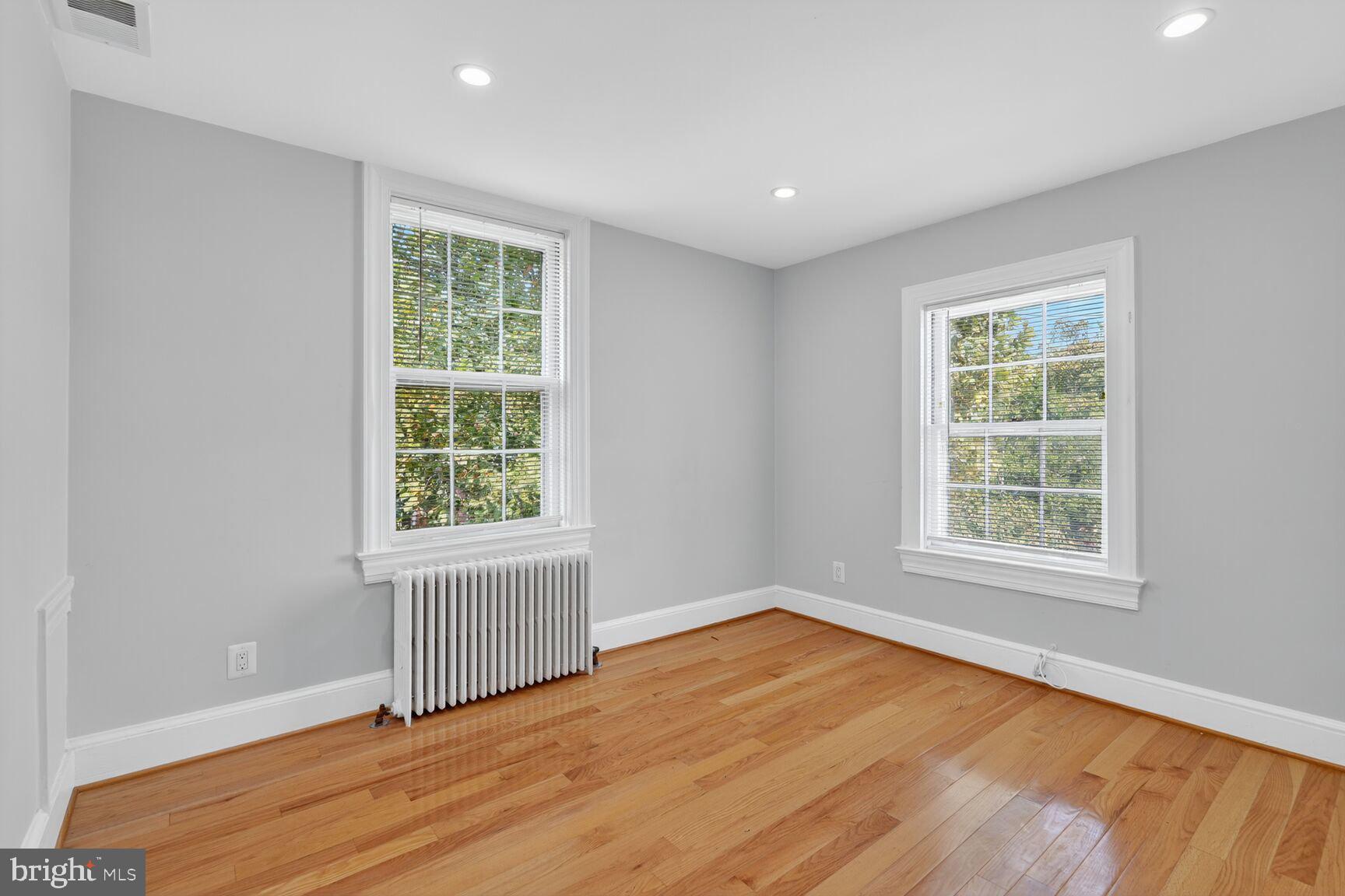 1363 28th Street Northwest, Unit 3 Washington, DC 20007 - Photo 2 of 13 an empty room with wooden floor and windows